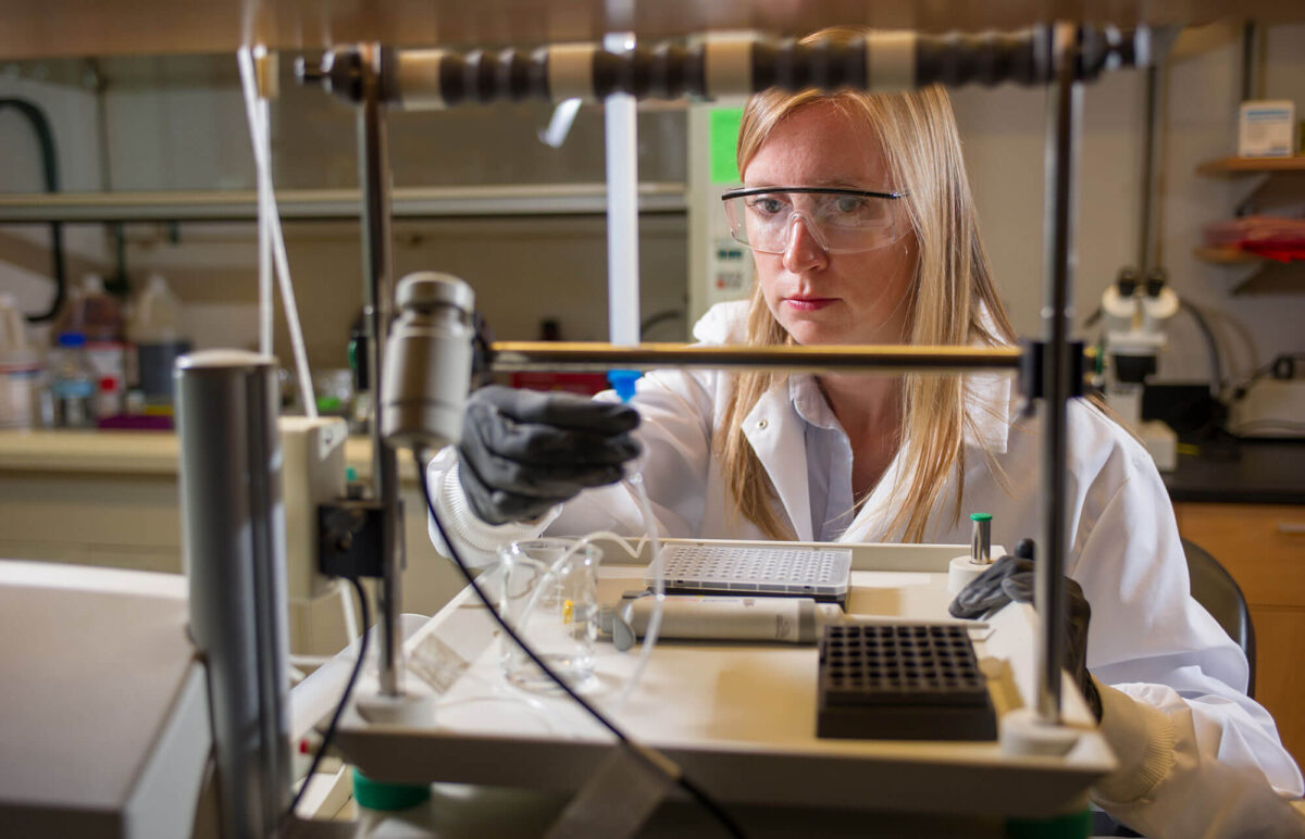 A female scientist conducts tests in a lab
